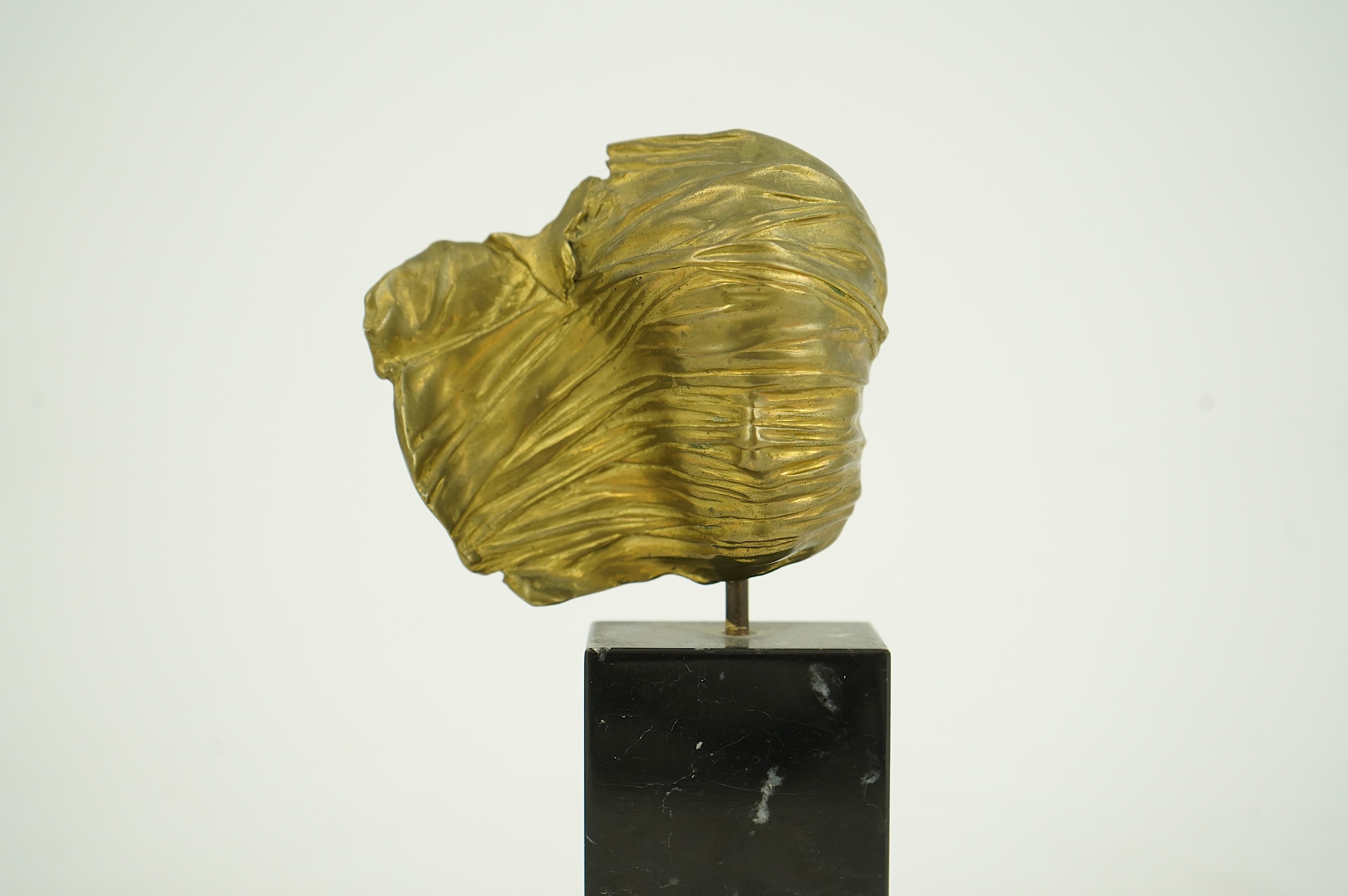 Igor Mitoraj (Polish, 1944-2014), Visage Envolé, bronze and black marble, 16.5 x 7 x 2.5cm